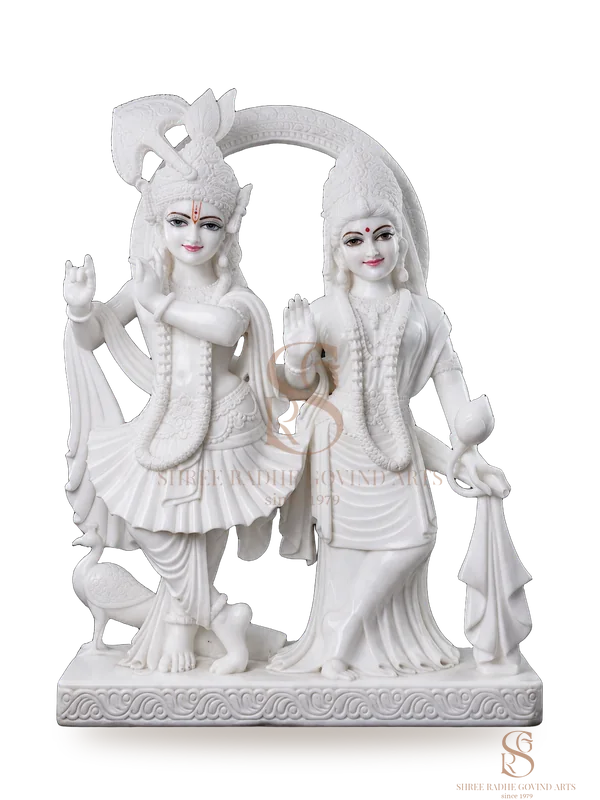 Radha Krishna carved together on one marble base, with a peacock